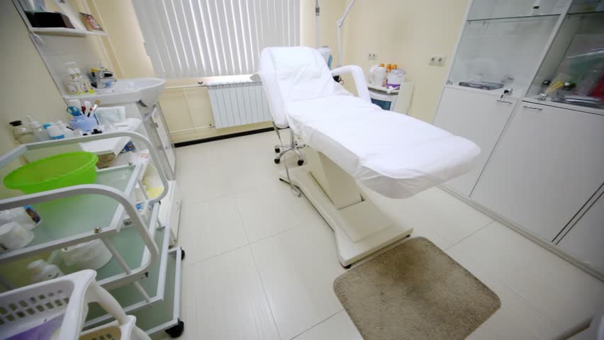 Cosmetology armchair stand at room center in beauty parlour near window
