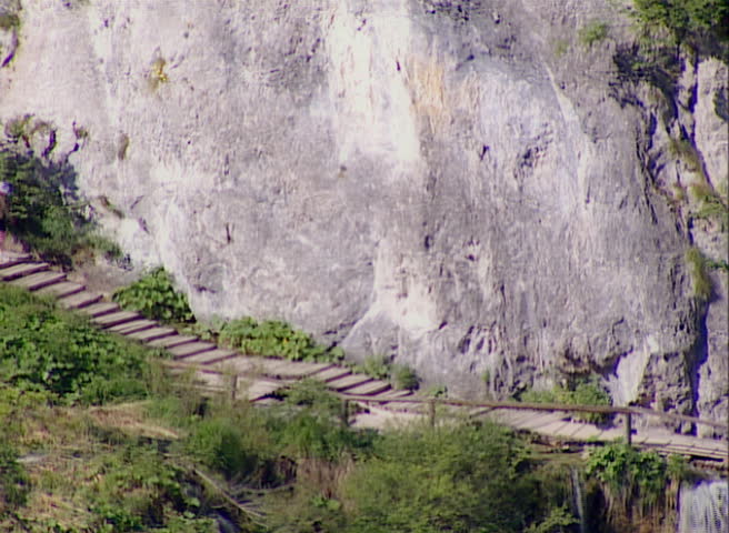 Lakes with waterfall in Croatia, Europe. Detail with footpath above waterfall. Location: Plitvice, National Park Plitvicka jezera.