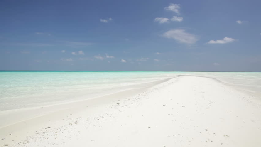 young tourists walking on sandy beach ready for snorkeling