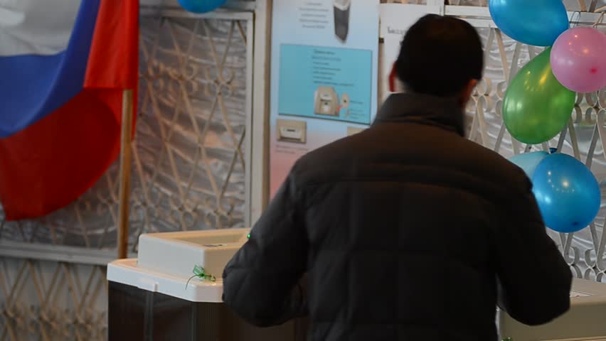 ULAN-UDE, RUSSIA - MARCH 4: Voters at the local polling station 699 stand in line to voting booths at the presidential election of Russian Federation on March 4, 2012 in Ulan-Ude, Buryatia, Russia.