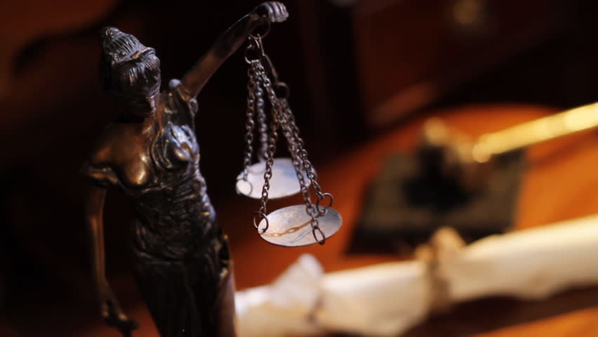 Hammer, the papyrus and the Woman with justice scales in the dark on a table