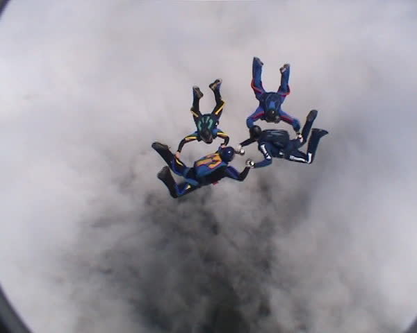 Four skydivers doing formations