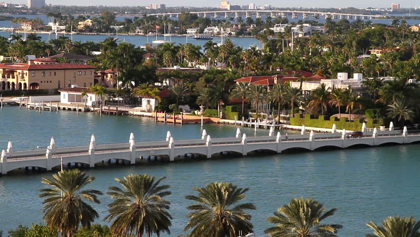 sailboats in miami bay area on a beautiful summer day, aerial view, near star island mansions