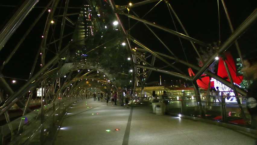 SINGAPORE - CIRCA DECEMBER 2011: Tourists walking along Helix bridge decorated for Christmas, circa December 2011 