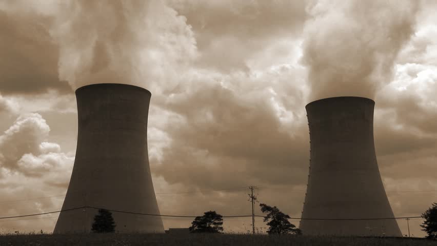 A nuclear power plant with two cooling towers in  tritones of brown.