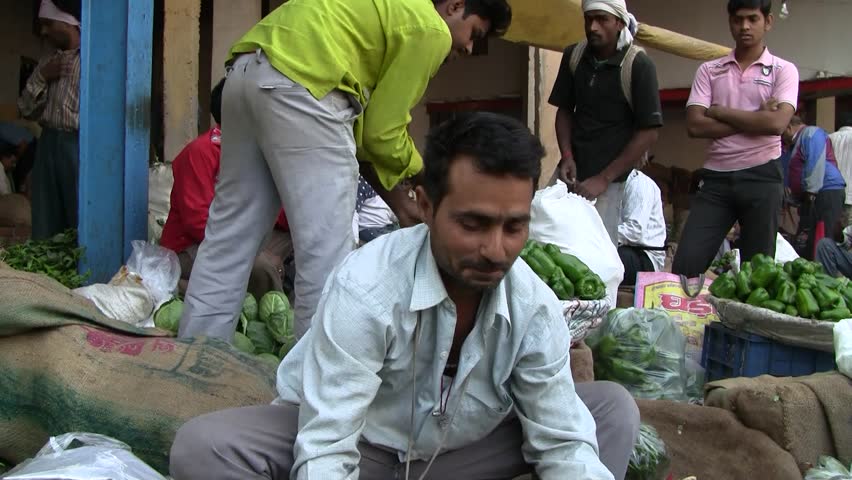 DELHI - NOV 13: Market vendor selling vegetables on a local market on November 13, 2011 in Delhi, India. India ranks second worldwide in farm output. Agriculture employs 52.1% of the total workforce.