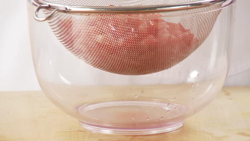 Diced tomato draining in a sieve
