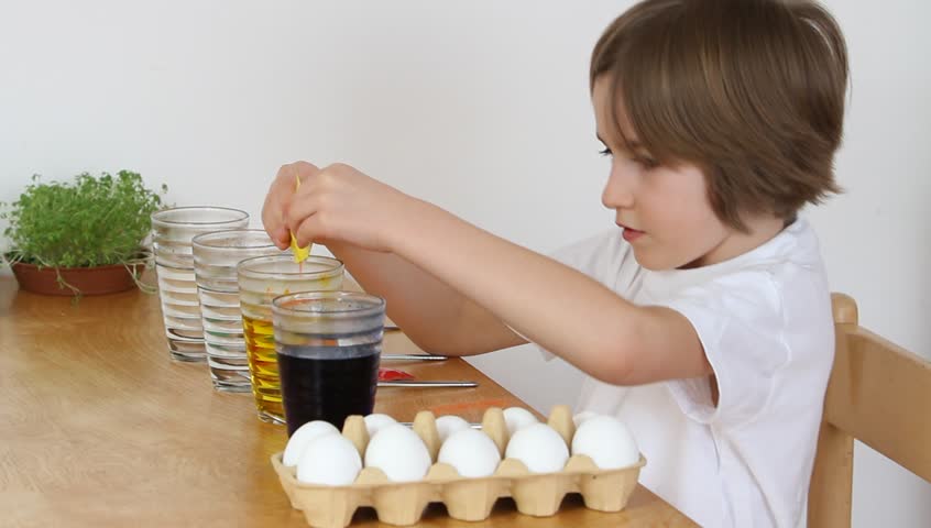 Little girl prepares powder colors for dying Easter eggs (HD version)
