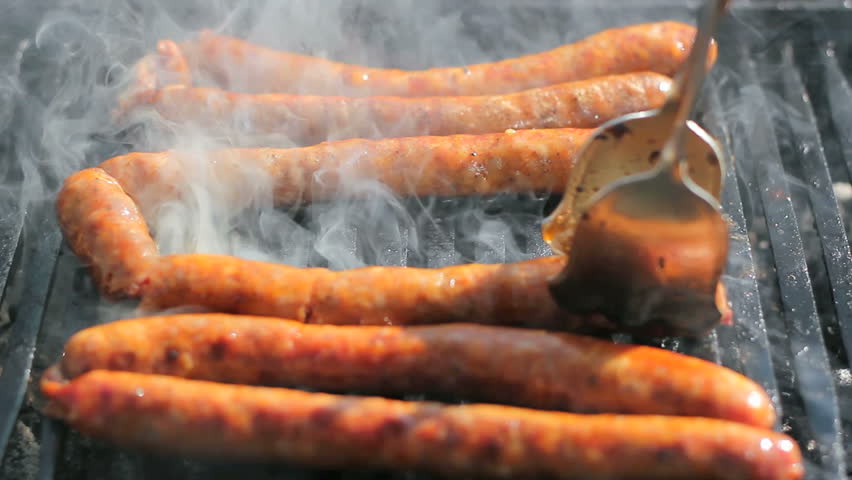 Sausages on the barbecue grill. Shallow depth-of-field. Selective focus. HD1080i.