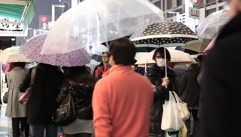 TOKYO - MARCH 18: Pedestrians in Ginza in Tokyo on a rainy March 18, 2012. Even during bad weather Tokyo's most important luxury district Ginza is filled with shoppers from all over the world.