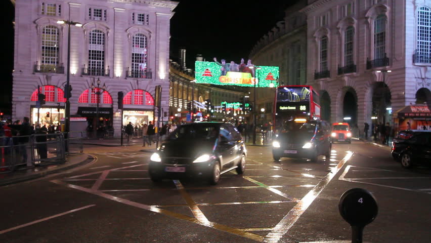 LONDON, UK - DECEMBER 27: Busses and other traffic drive by on Piccadilly Circus on December 27, 2011 in London, UK. Piccadilly Circus is one of the main entertainment areas of London.