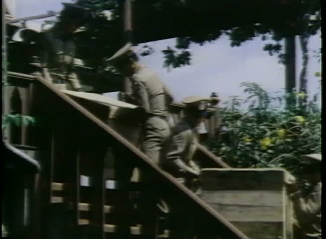 Policemen carrying wooden crates down stairs