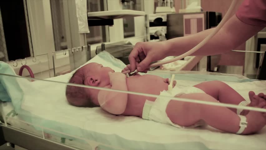 A newborn baby at the hospital born just minutes before being cleaned by the nursing staff.