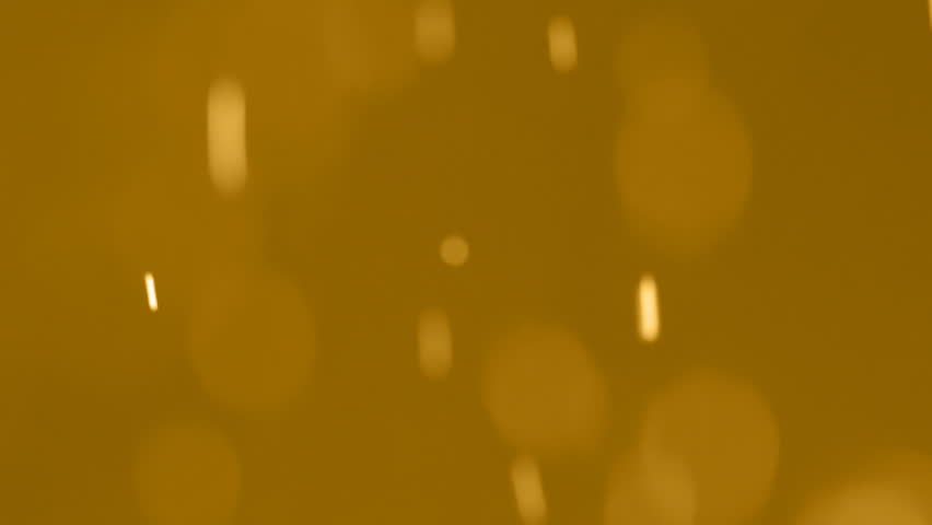 Golden Dust Spots Out Of Focus (HD). These are real falling dust particles out of focus in front of a very high intensity halogen light being bounced from a golden reflector. 