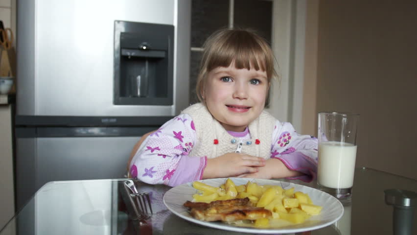 Happy girl eating. Thumbs up. She showing Ok