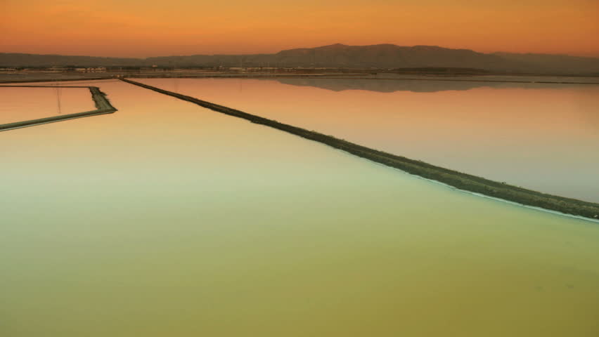 Aerial view of salt ponds evolving from a natural restoration project