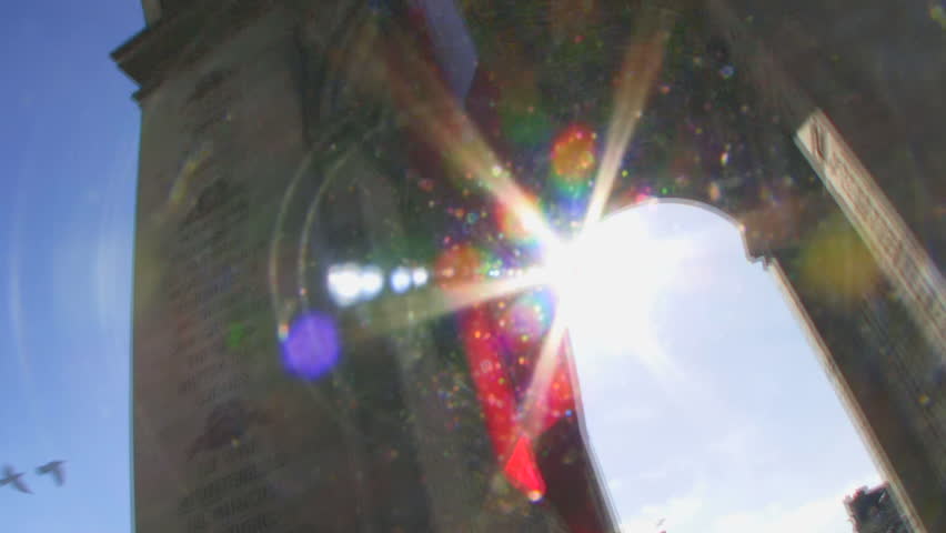 Slow motion, Low angle view of flag under Arc de Triomphe, Paris, France