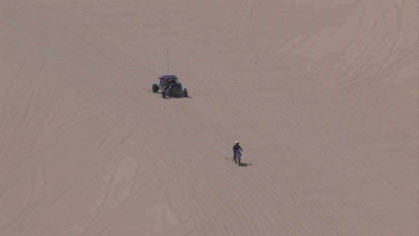 Dune buggy, ATV and motorcycles on Sand Mountain  Little Sahara recreation area Utah.  700 vertical feet of sand used for off road vehicles, fun and recreation. Racing up sand. Central Utah.