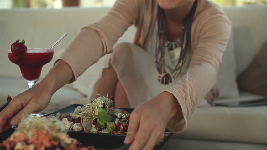 Waiter serving plates with salad in restaurant
