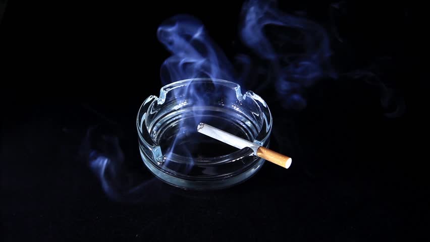 Smoldering Cigarette on the black background, Timelapse
