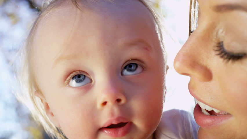 Portrait in close up of beautiful young mother and her baby