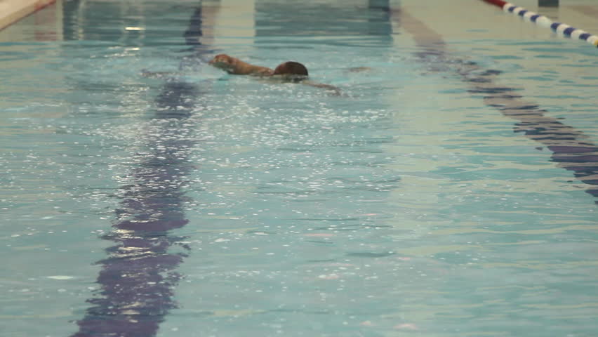 Male swimming in swimming pool in gym