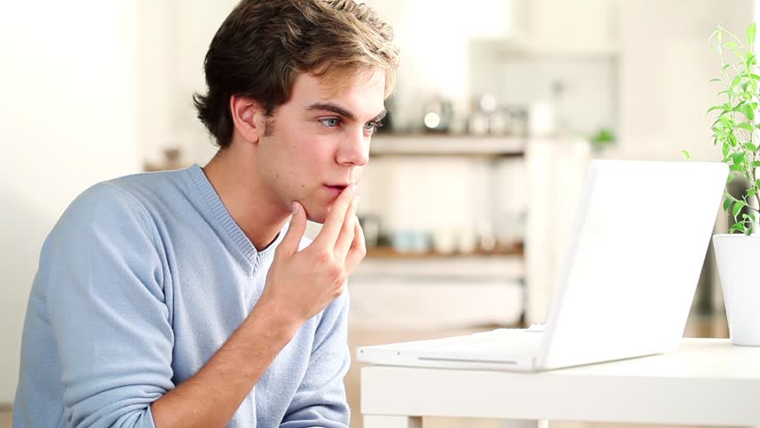 Attractive successful young man is excited winning online