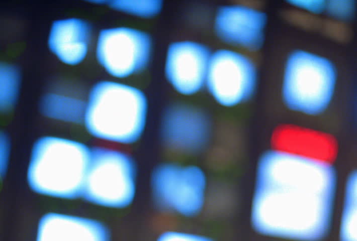 Pull focus on TV monitors in newsroom 