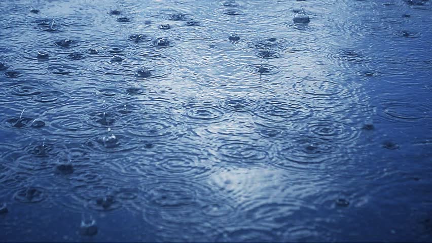strong rain drops over city pavement 