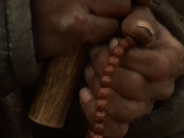 Man is counting beads (buddhist monk)