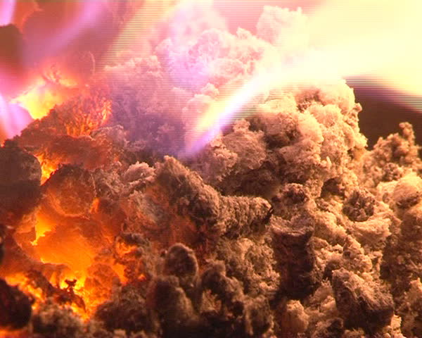 closeup of burning straw granules in boiler. flames and fire detail. ecologic fuel use for home heating.