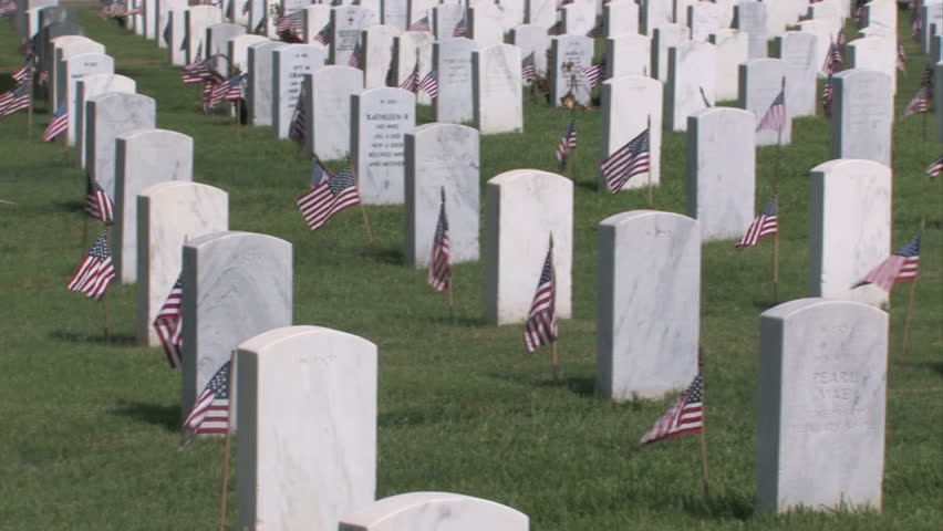 Pan right of graves and headstones at Ft Sam Houston Veterans Cemetery San Antonio Texas. Heroes and warriors, members of military and veterans. Marble headstones with inscriptions.