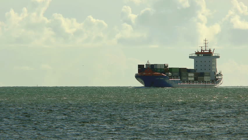 Large cargo ship approaches the harbour of Lisbon.