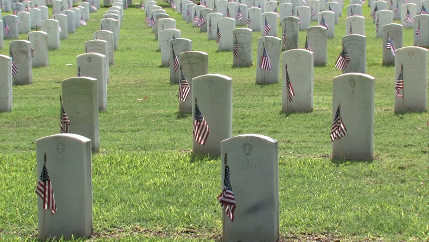 Graves and headstones closer at Ft Sam Houston Veterans Cemetery San Antonio Texas. Heroes and warriors, members of military and veterans. Markers and flags. Ft Sam Houston, Texas.