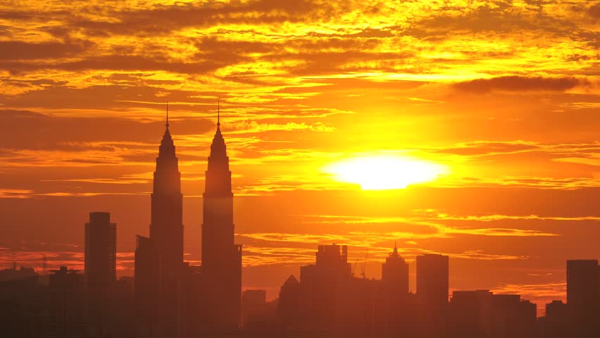 Time lapse of sun setting over skyline of Kuala Lumpur, Malaysia