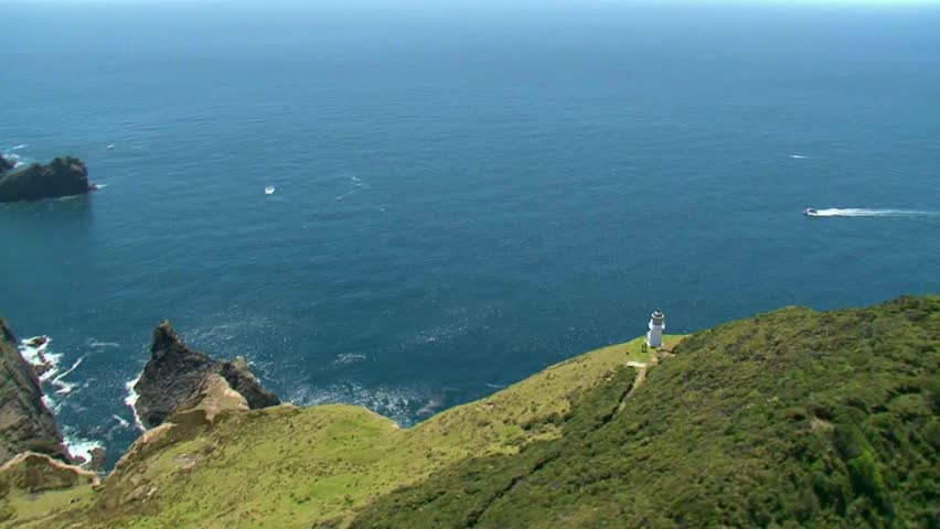 Scenic helicopter flight over Cape Brett lighthouse, Piercy Island in the distance also known as âThe hole in the rockâ.