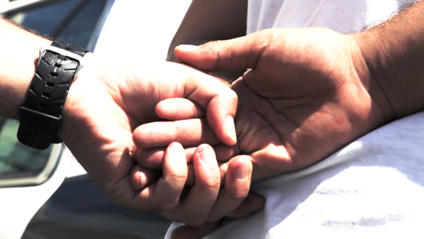 close up of person being handcuffed