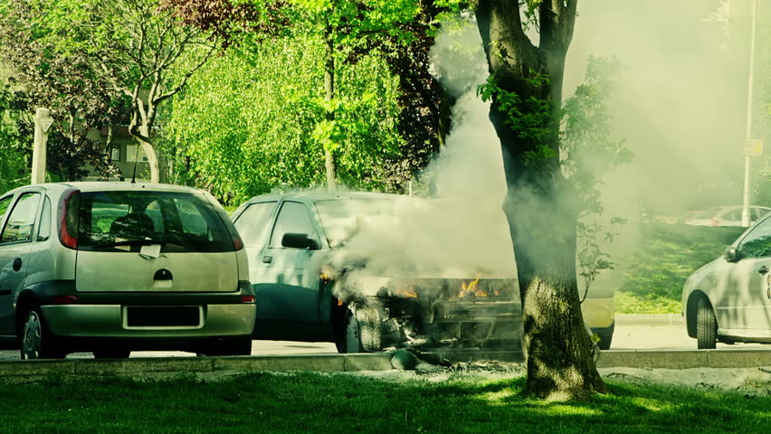 Car engulfed in flames with lot of smoke.
