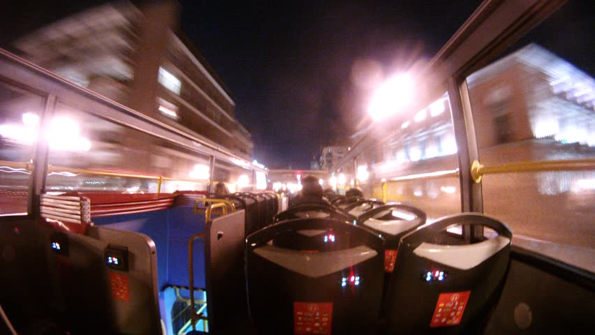 MADRID - MAR 10: (Timelapse View) Passengers go on streets of night city in open bus, on Mar 10, 2012 in Madrid, Spain