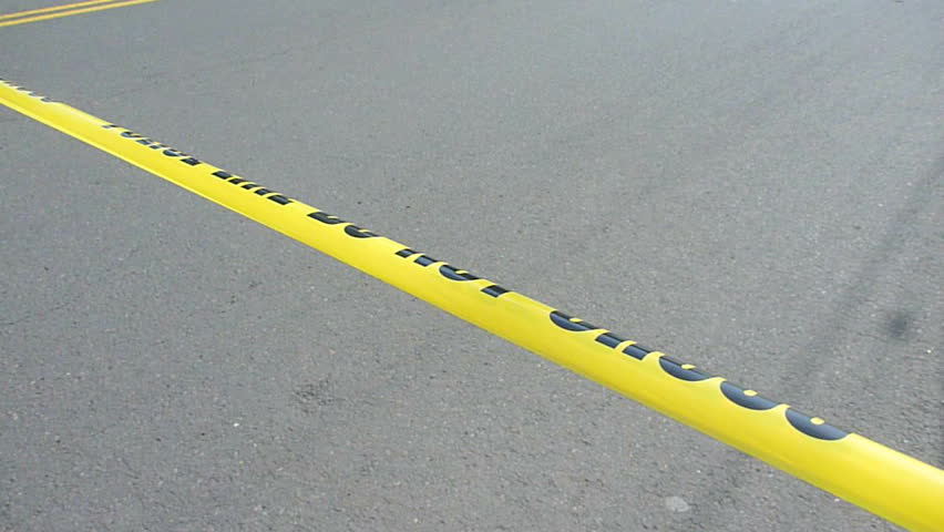 Police caution line reads Do Not Cross at crime scene.