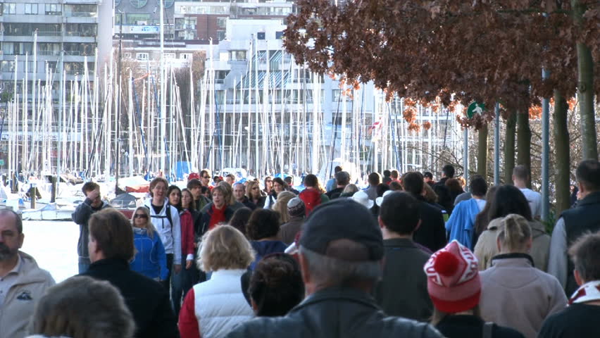 VANCOUVER, BRITISH COLOMBIA CIRCA NOVEMBER 2010: Time lapse of people walking by marina in Vancouver, Canada during the 2010 Olympic Winter Games.