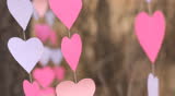 Fluttering in the wind garlands of paper hearts, Close up 
