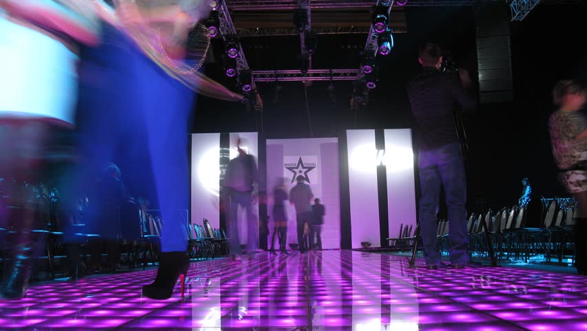 MOSCOW - APR 8: (Timelapse View) Visitors are photographed on podium after mannequin parade on VOLVO - Week of fashion in Moscow in Gostini dvor, on April 8, 2012 in Moscow, Russia