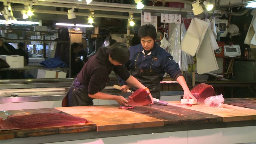 TOKYO, JAPAN - CIRCA 2008: Carving tuna at Tsukiji wholesale fish market
