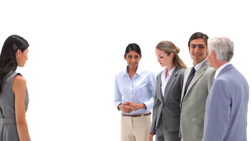 Businesswoman using a megaphone to shout at co-workers against a white background