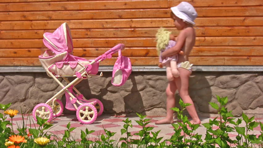 little girl with toy baby carriage 