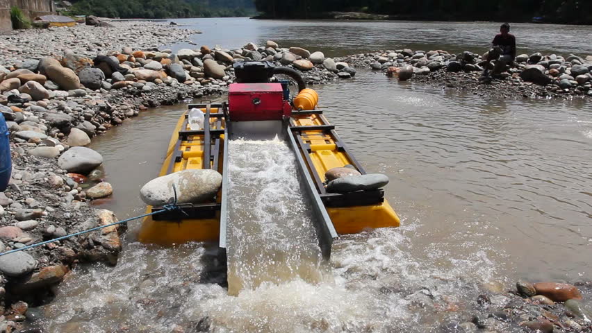 Suction dredge mining placer gold deposits on the Rio Napo in the Ecuadorian Amazon.