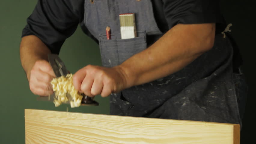Carpenter planing a wooden board