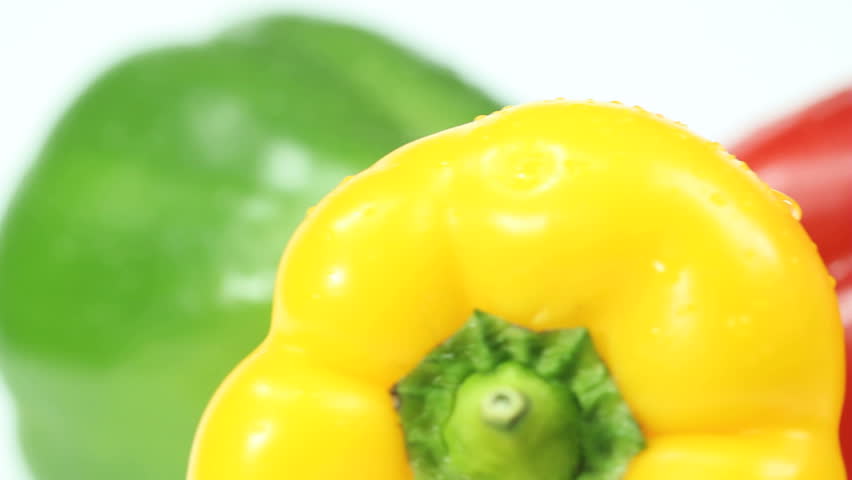 Red, Green and Yellow paprika rotating on white background, this vegetable is also known as bell pepper. Video loop is seamless and useful for motion background related, food, health, organic topics