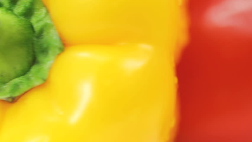 Yellow Red and Green Bell Peppers seamlessly rotating; vegetable also known as paprika. Useful for motion backgrounds related to food, health, organic and wellness topics.